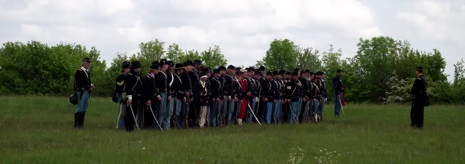 Photos of the re-enactment taking place and soldiers fighting.