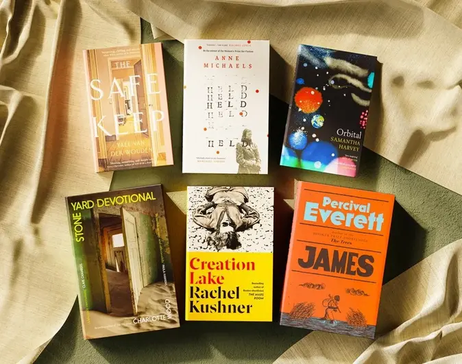 The six shortlisted books for the Booker Prize 2024 laid out on a table. The books lie flat next to each other on the table, their covers visible.